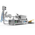 Low viscosity JORES TECHNOLOGIES® piston filling machine with 316 and 304 SS. The piston filler is made out of stainless steel and there's a yellow and grey foot pedal resting on the side which is part of the filler.